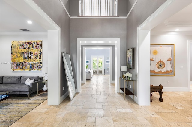 foyer featuring ornamental molding and a high ceiling