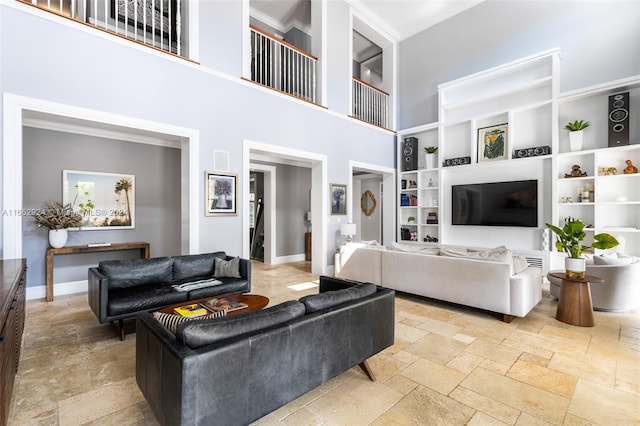 living room featuring built in shelves and a towering ceiling