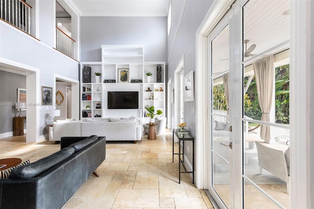 living room featuring a towering ceiling and french doors