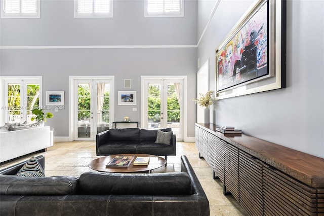 living room with french doors and a towering ceiling