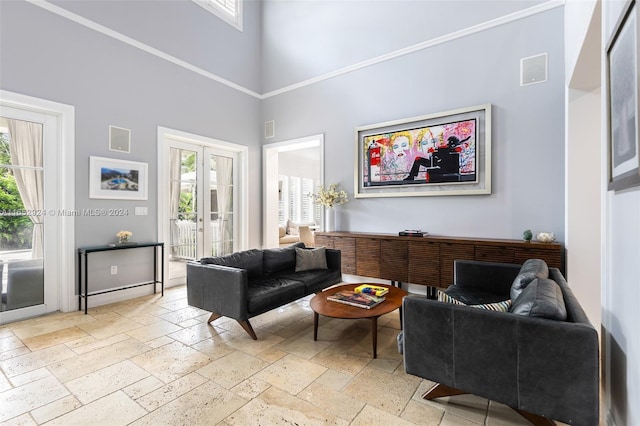 living room with a high ceiling and french doors