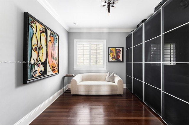 sitting room featuring dark hardwood / wood-style flooring and ornamental molding