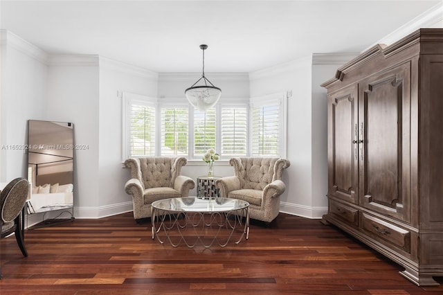 sitting room featuring a chandelier, dark hardwood / wood-style floors, and crown molding