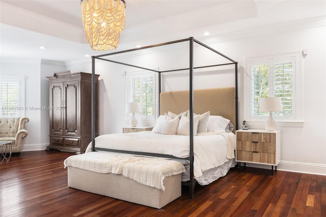 bedroom featuring an inviting chandelier, dark hardwood / wood-style flooring, ornamental molding, and multiple windows