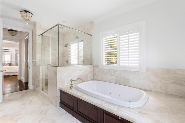 bathroom featuring ornamental molding and independent shower and bath