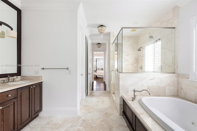 bathroom featuring vanity, ornamental molding, and independent shower and bath