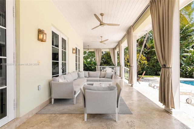 sunroom featuring ceiling fan and wooden ceiling