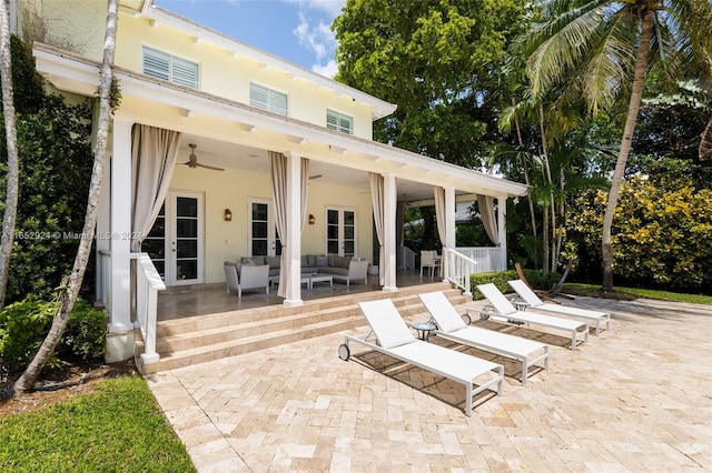 view of patio featuring french doors, an outdoor living space, and ceiling fan