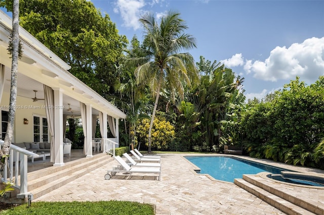 view of pool with an in ground hot tub, a patio, and ceiling fan