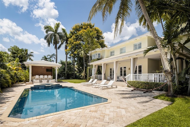 view of pool featuring an in ground hot tub, an outdoor bar, and a patio area