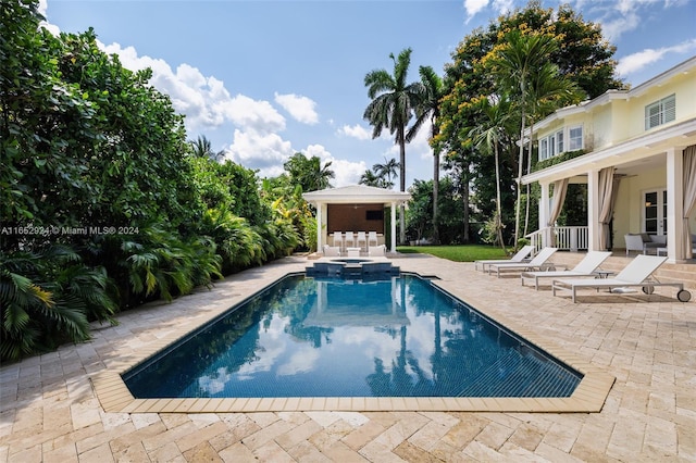 view of pool with ceiling fan and a patio area