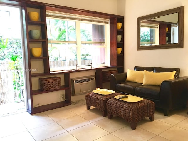 living area featuring a wall mounted AC and light tile patterned flooring