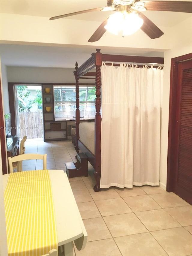 interior space with ceiling fan and light tile patterned flooring