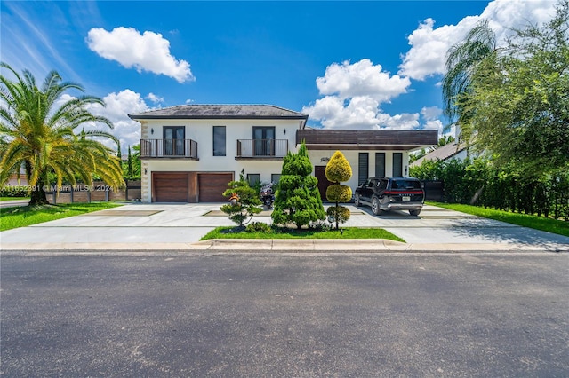 view of front of property with a balcony and a garage