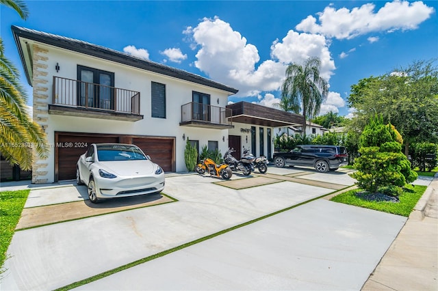 view of front of house featuring a balcony and a garage