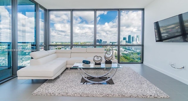 tiled living room featuring floor to ceiling windows