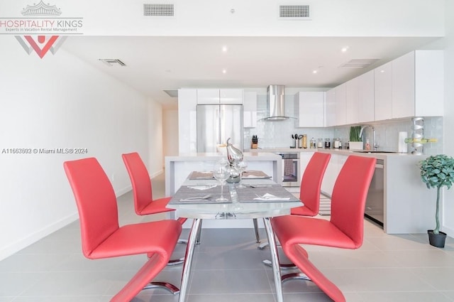 dining room featuring light tile patterned floors and sink