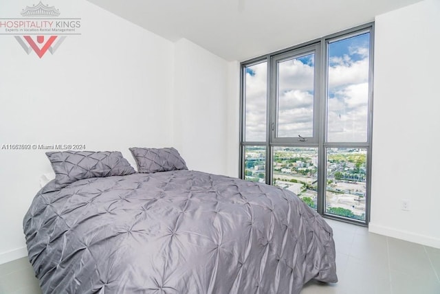 1600 NE 1st Ave Unit 1916, Miami, FL 33132 - tiled bedroom featuring expansive windows and baseboards