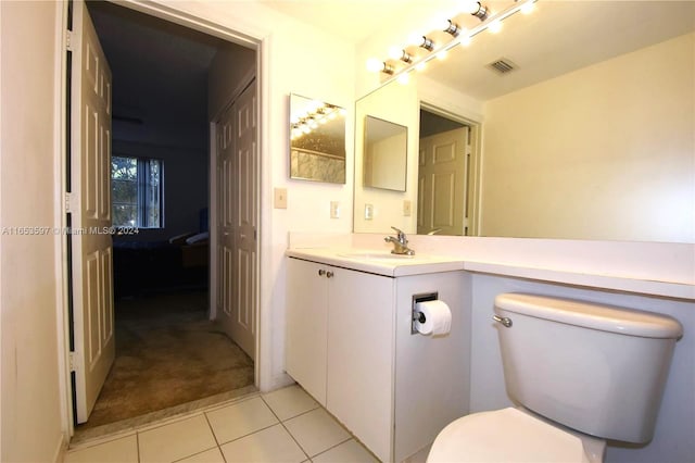 bathroom with vanity, toilet, and tile patterned floors