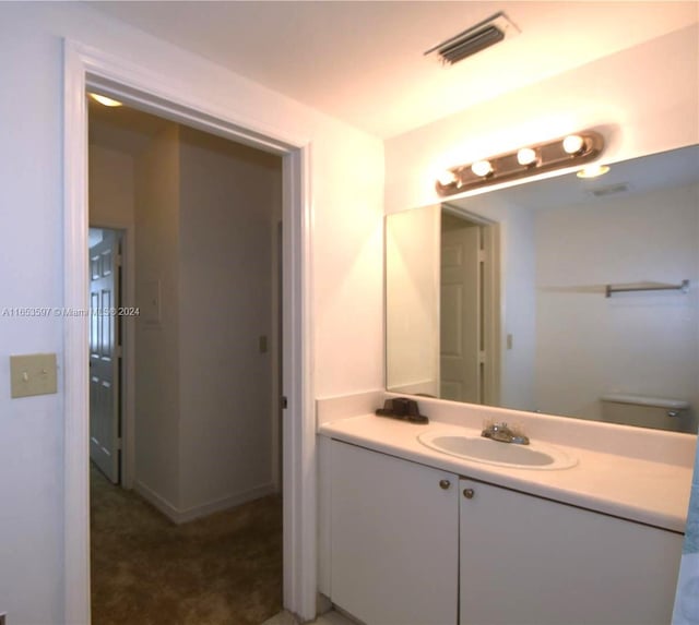 bathroom with vanity and toilet