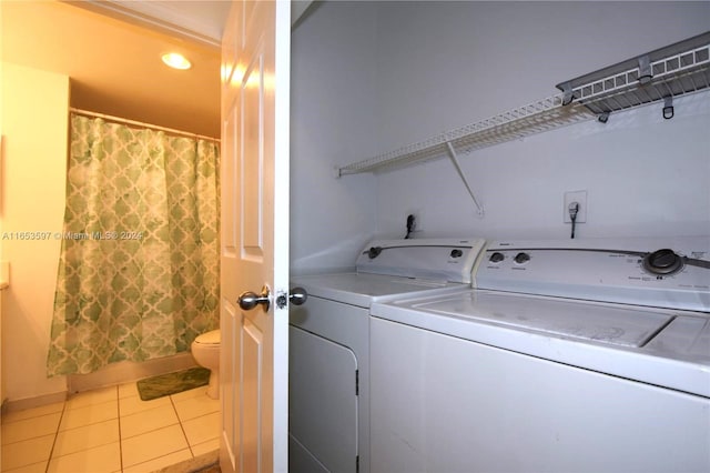 laundry room with washing machine and dryer and light tile patterned floors