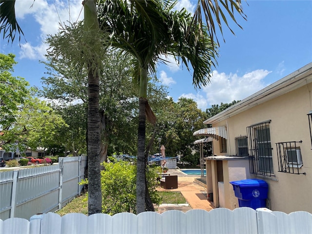 view of yard featuring a fenced in pool and a patio