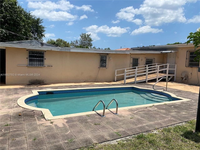 view of pool featuring a patio