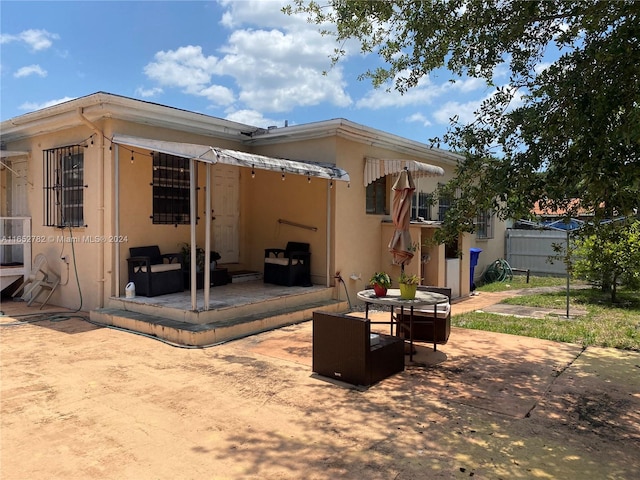 rear view of house featuring an outdoor hangout area and a patio