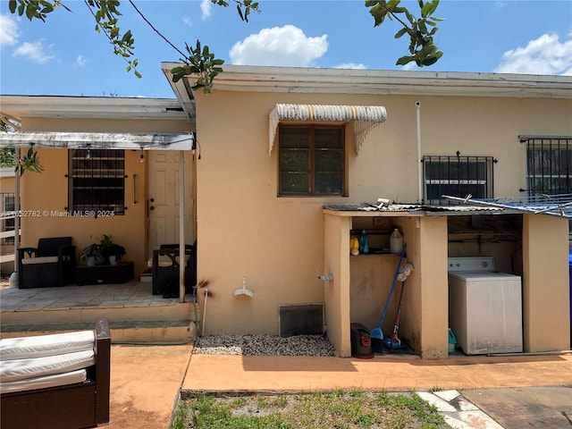 back of house with a patio and washer / clothes dryer