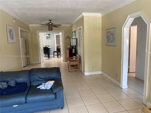 tiled living room featuring ceiling fan and ornamental molding