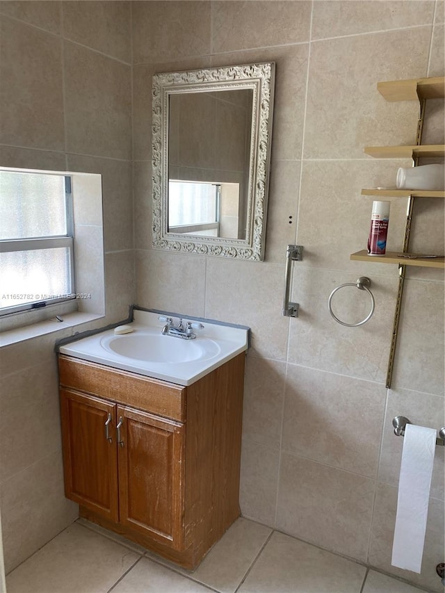 bathroom featuring tile walls, tile patterned flooring, and vanity