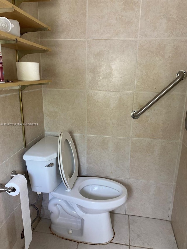 bathroom featuring tile walls, toilet, and tile patterned floors