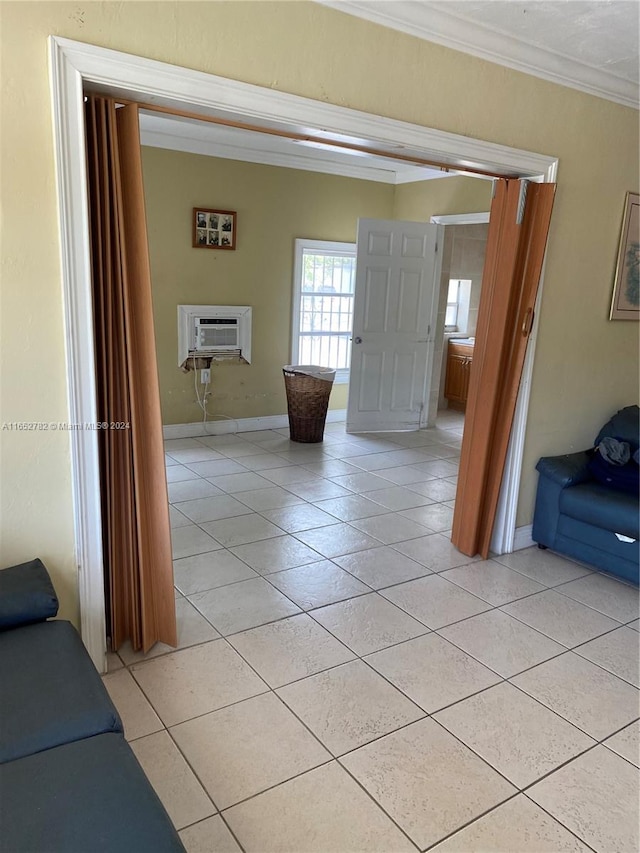 hall featuring a wall mounted AC, crown molding, and light tile patterned flooring