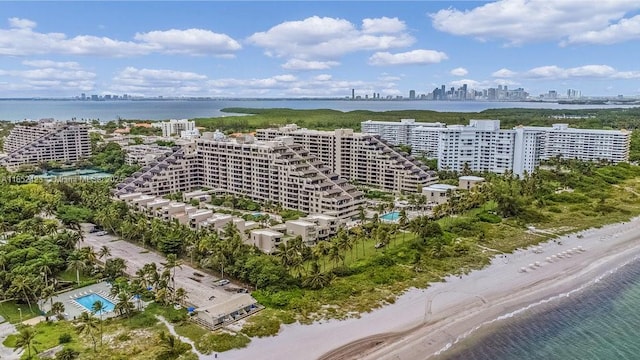 birds eye view of property with a beach view and a water view