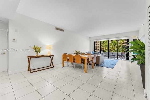 dining space featuring light tile patterned floors