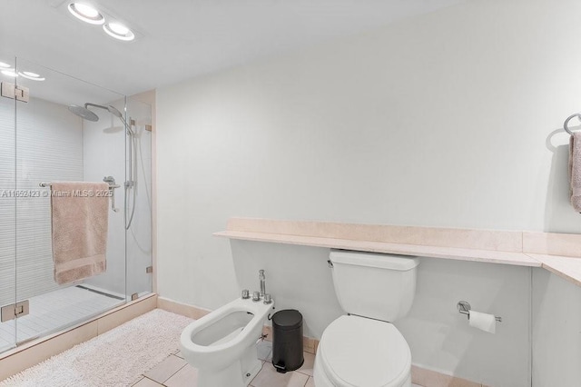 bathroom with tile patterned flooring, a shower with door, toilet, and a bidet