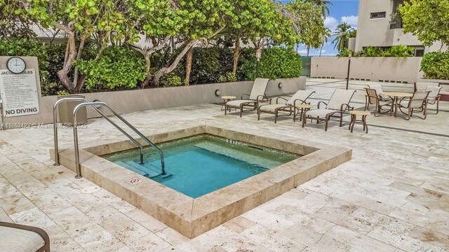 view of pool featuring a community hot tub