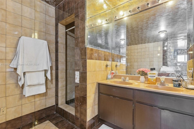 bathroom featuring tile walls, tile patterned flooring, a shower, and vanity