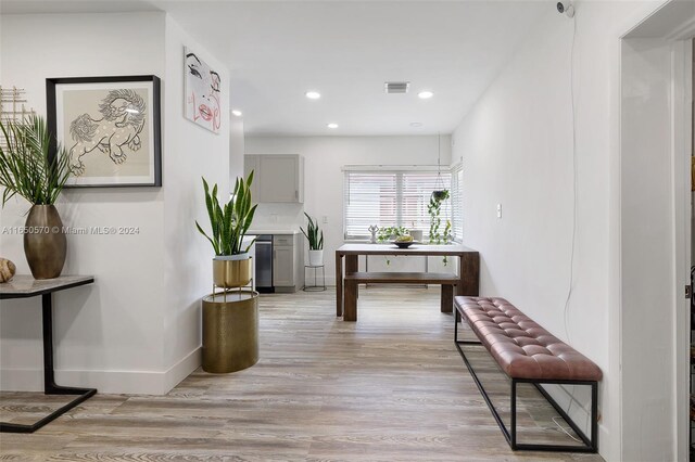 hallway with light hardwood / wood-style flooring