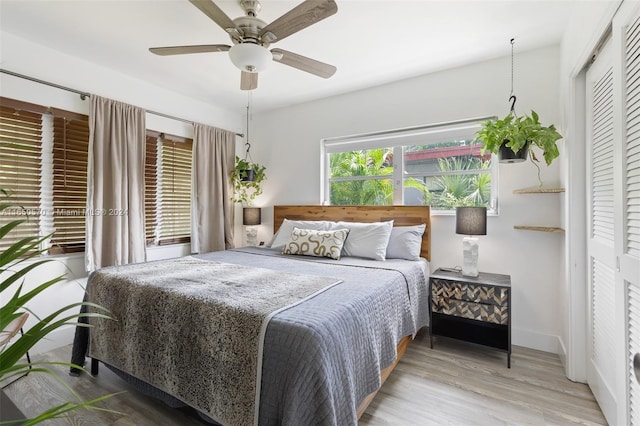 bedroom with ceiling fan, a closet, and hardwood / wood-style flooring