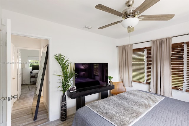 bedroom with light wood-type flooring and ceiling fan