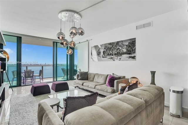 living room with a water view, floor to ceiling windows, and a notable chandelier