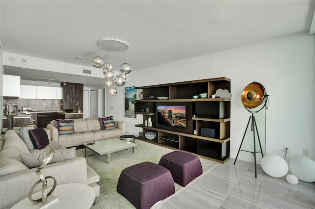 living room featuring a notable chandelier