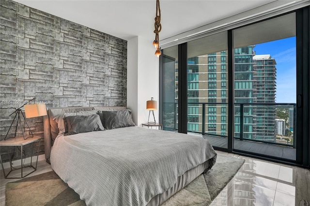 bedroom featuring light tile patterned floors and access to outside