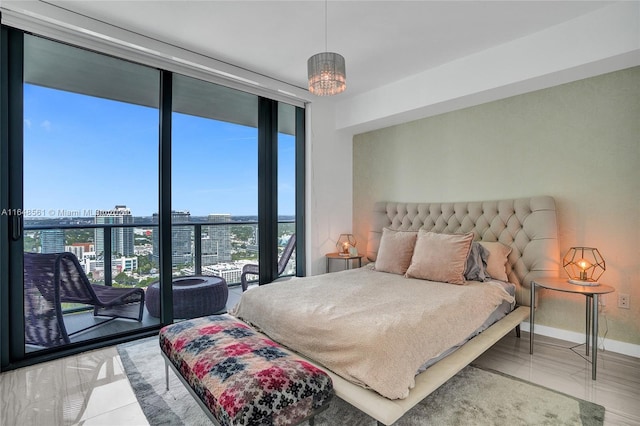 tiled bedroom with expansive windows, a chandelier, and access to outside