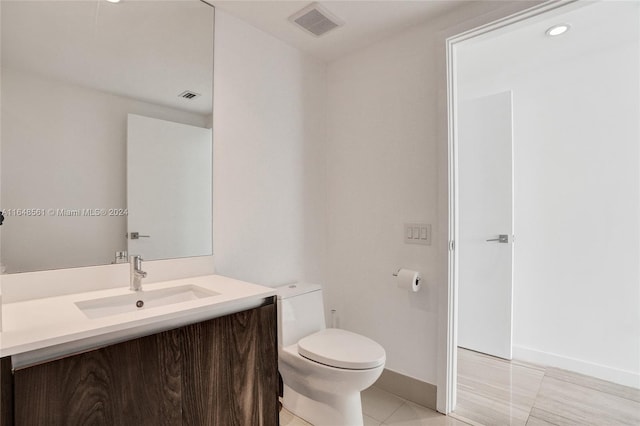 bathroom with tile patterned floors, toilet, and vanity