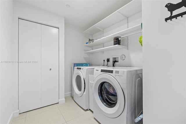washroom with washer and dryer and light tile patterned floors