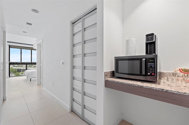hallway featuring light tile patterned flooring
