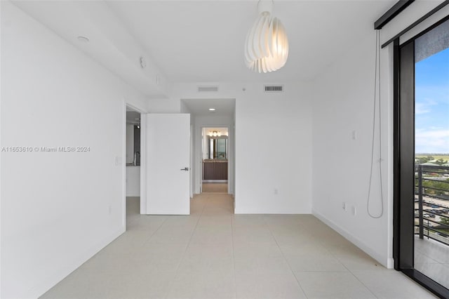 unfurnished room with light tile patterned flooring