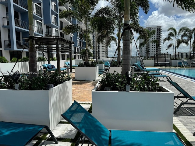 surrounding community featuring a pool and a patio area
